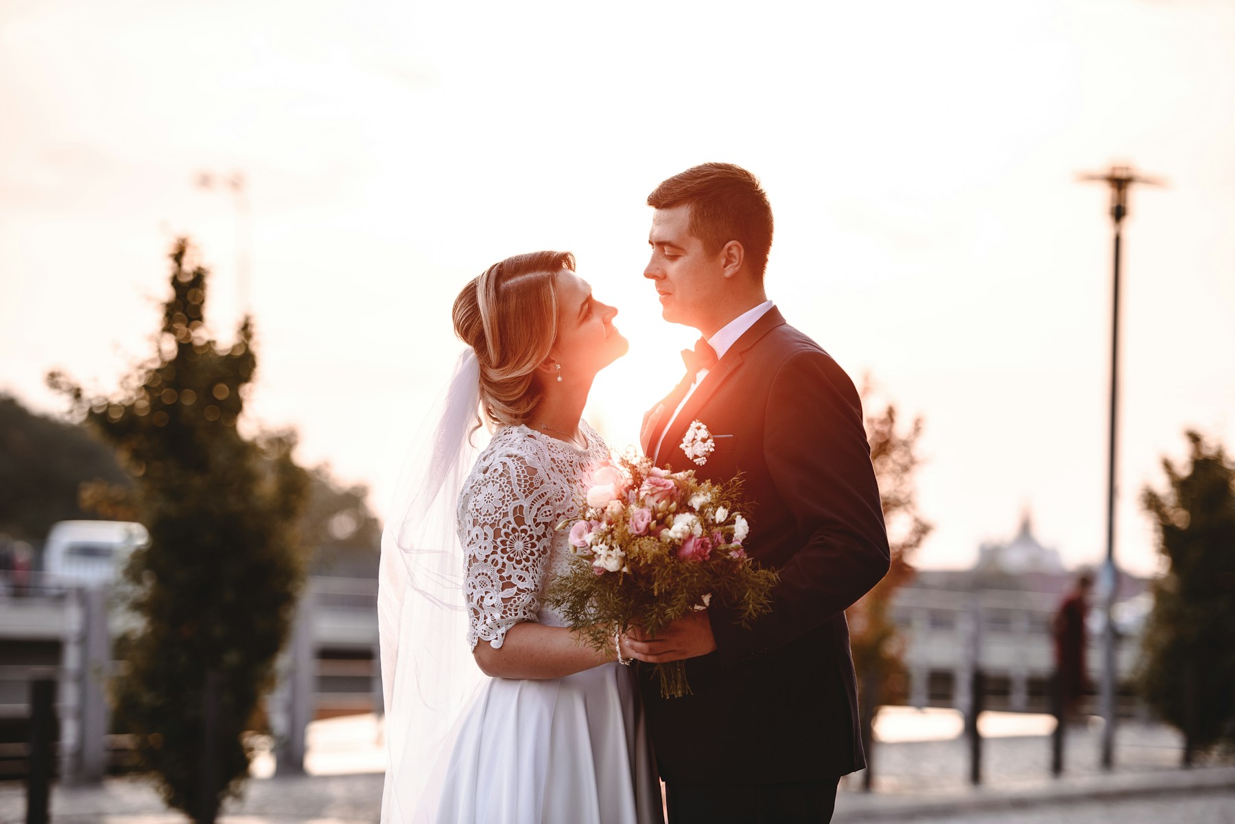 Placeholder: Bride and groom embracing in warm light